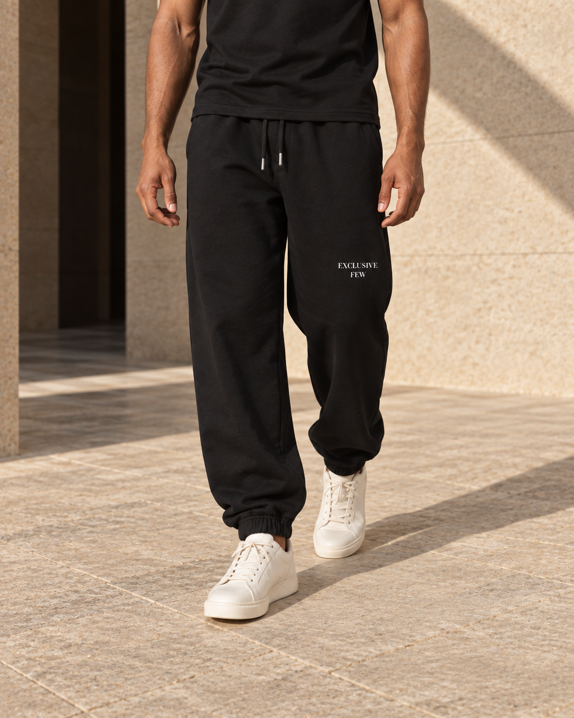 Black Urban Baggy Sweatpants shown on a model in motion, with cuff and drawcord details.